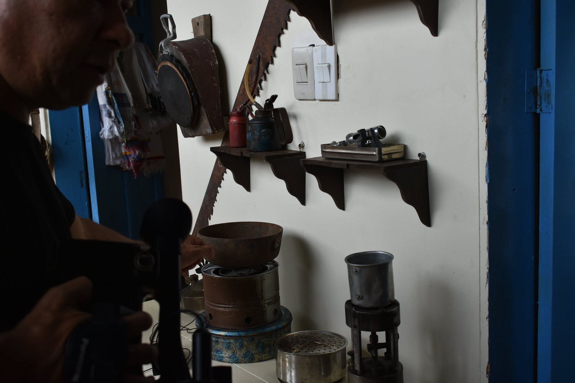 Hand-cranked coffee grinders hanging on the farm wall