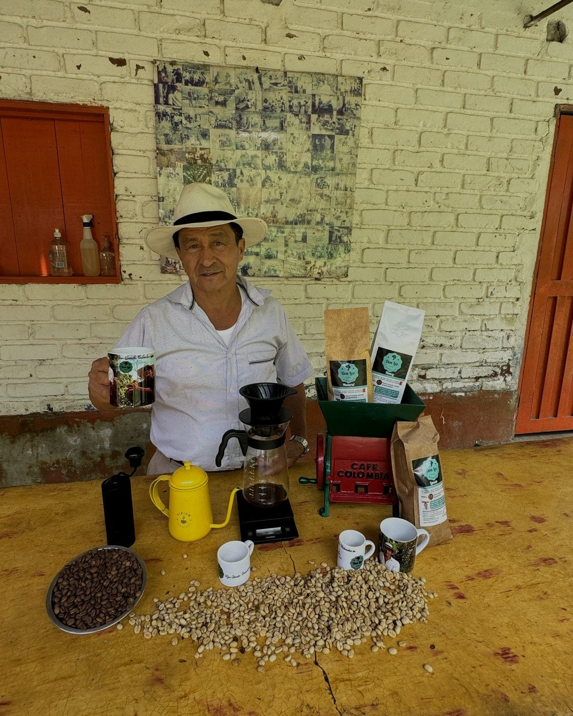 León Campo at his stand with the grinder, the bags and coffee both ground and whole